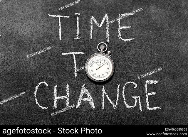 time to change concept handwritten on chalkboard with vintage precise stopwatch used instead of O