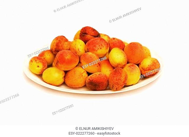 Many colourful red apricots in the plate