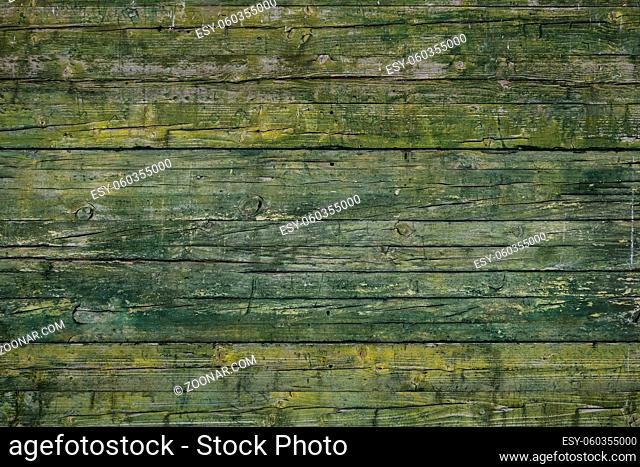 Beautiful wallpaper texture of worn green rusty paint in a wood plank wall