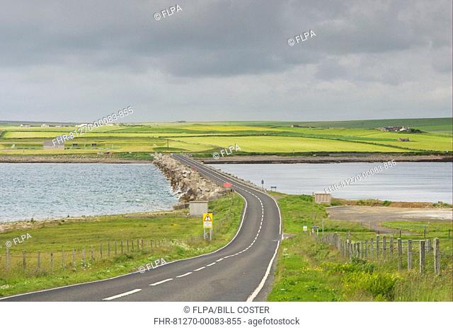 Road on causeway linking islands, originally built to close entrance and protect Scapa Flow, Churchill Barrier, between Burray and Mainland, Orkney, Scotland
