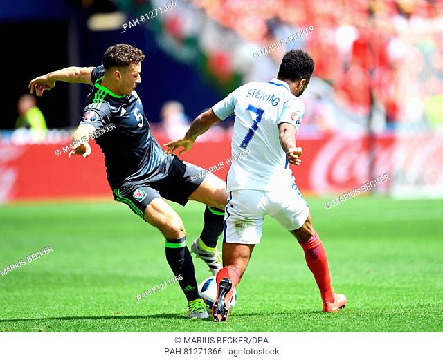 Raheem Sterling (r) of England and James Chester (l) of Wales challenge for the ball during the Euro 2016 Group B soccer match between England and Wales at the...