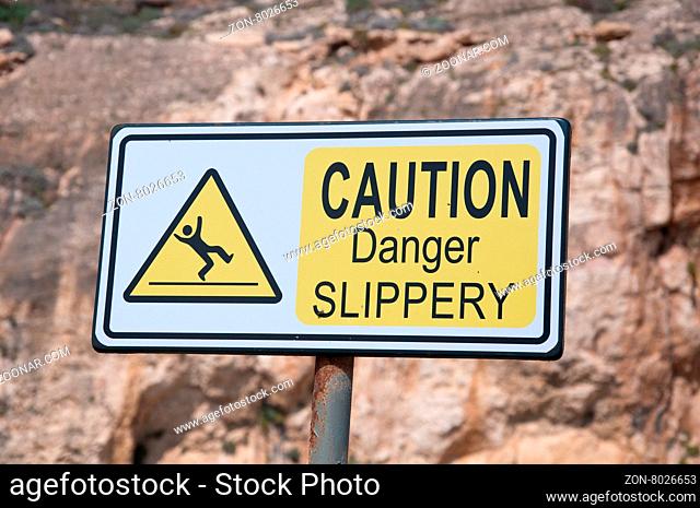 Sign indicating attention danger of slipping