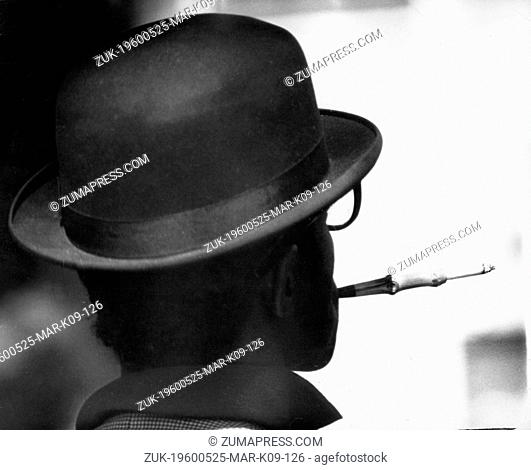 May 25, 1960 - London, England, U.K. - With the well-brushed bowler hat the elegant cigarette holder it could be the perfect English gentleman - but it's not