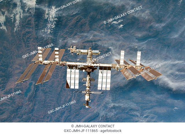 Backdropped by rugged Earth terrain, the International Space Station is featured in this image photographed by an STS-130 crew member on space shuttle Endeavour...