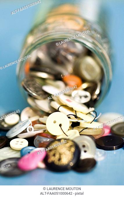 Buttons spilling out of jar