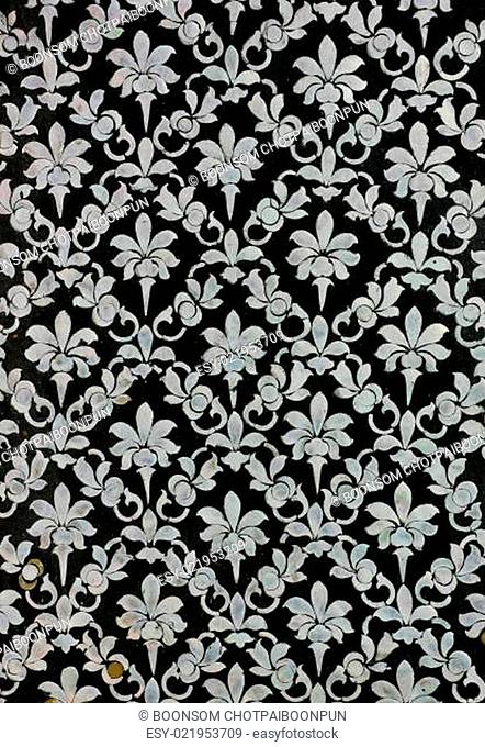 Thai floral art with mother of pearl inlay on Buddhist temple's door, Thailand