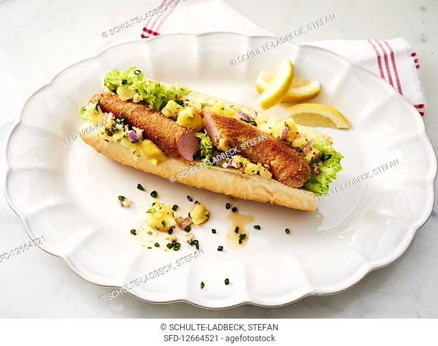 Viennese-style hot dog with potato salad and lemon wedges