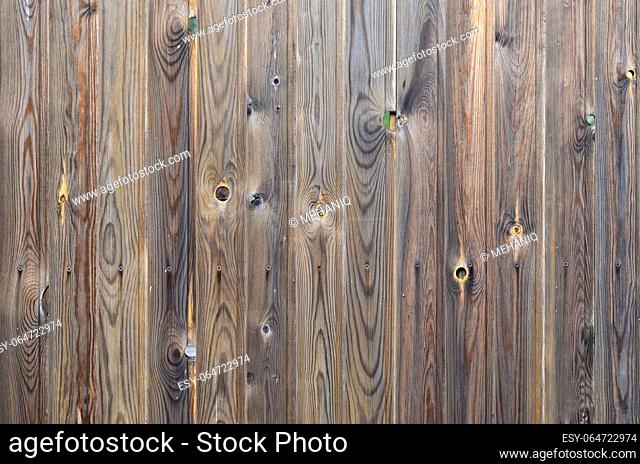 Old grunge dark brown wood panel pattern with beautiful abstract grain surface texture, vertical striped background or backdrop in architectural material...