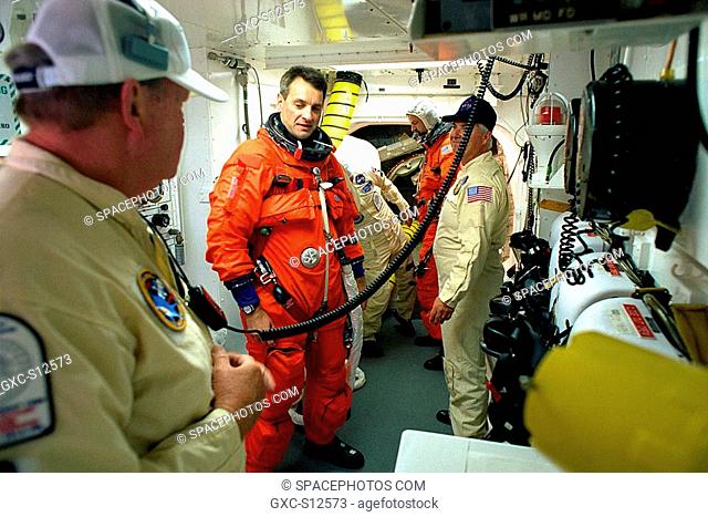 04/17/1998 --- STS-90 Mission Specialist Richard Linnehan, D.V.M., is assisted by NASA and USA closeout crew members immediately preceding launch for the nearly...