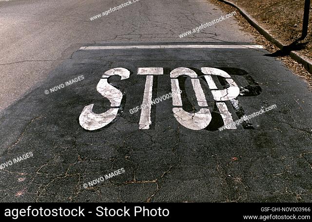 STOP stenciled on Asphalt Road