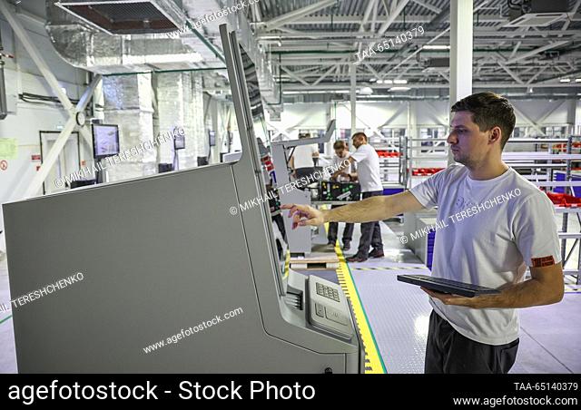 RUSSIA, MOSCOW - NOVEMBER 24, 2023: Workers are seen at a production facility manufacturing BFS cash machines at Moskva Technopolis
