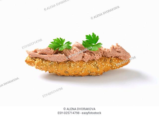 fresh bread roll with pate and parsley on white background