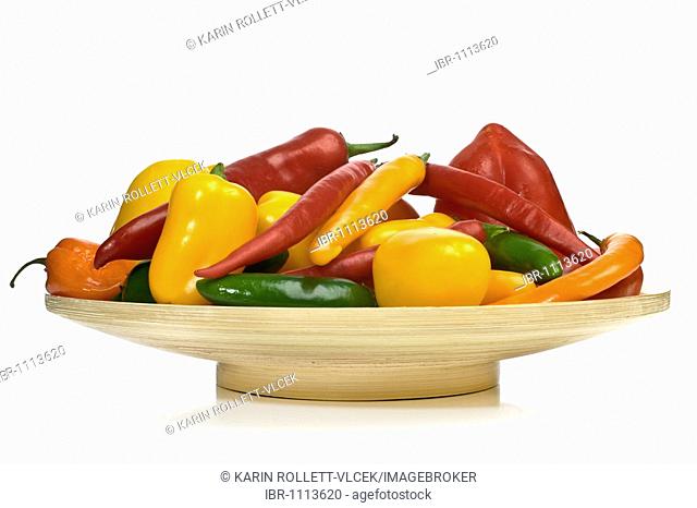 Colourful mixed vegetables on a wooden plate, capsicums, pepperonis and chillies