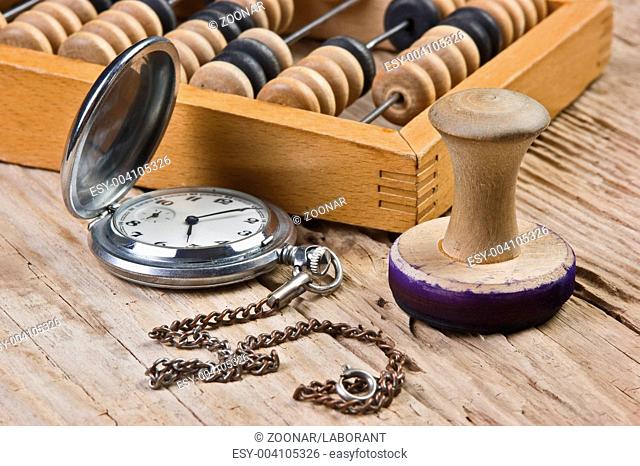 pocket watch, abacus and stamp