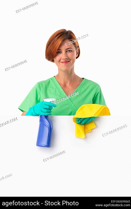 A woman cleaning lady with a rag in her hand holds an air freshener spray. House cleaning concept or office cleaning concept. Blank banner