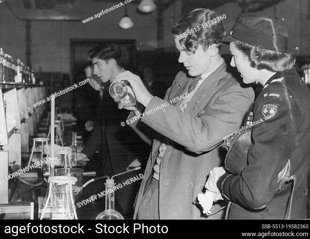 ***** Lady Louis watching J. H. Pryor make an experiment in the chemistry school at the University. April 24, 1946
