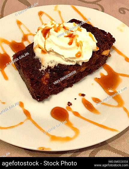 Chocolate cake with cream and toffee syrup