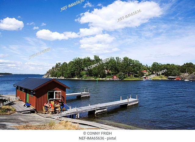 Dinner by a boathouse in the archipelago of Stockholm Sweden