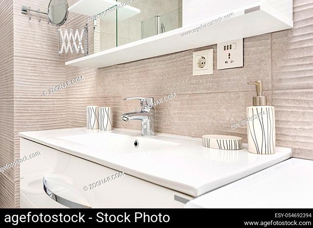 Sink with shelf and mirror in modern bathroom