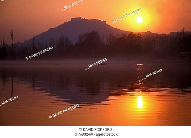 Fishermen make their way home in canoes as the sun sets over Nigeen Lake, Srinagar, capital of Indian-administered Kashmir, India, Asia