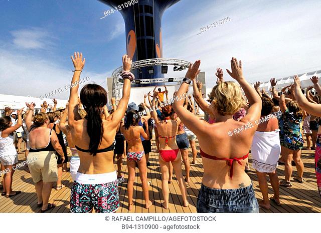 Women dancing on the deck of a cruise ship
