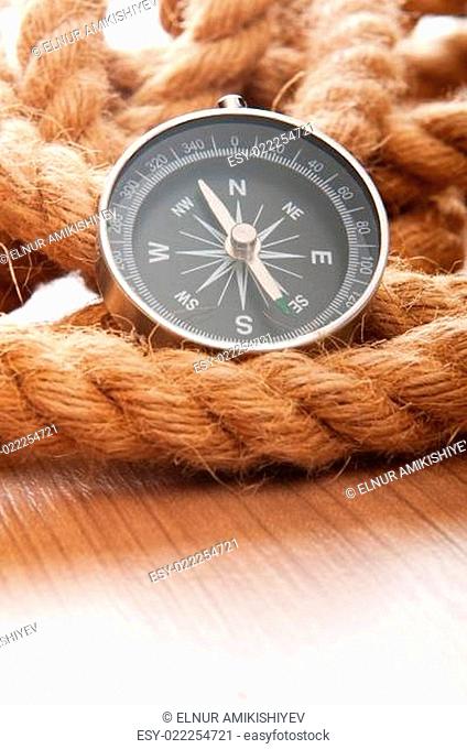 Compass and rope in travel and adventure concept