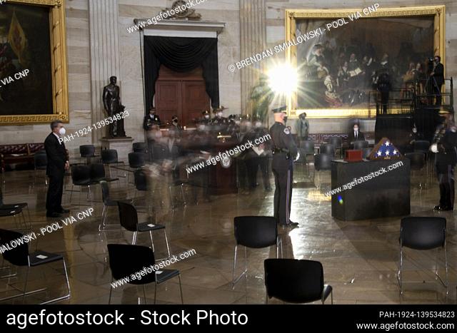 People leave after a ceremony for Capitol Police officer Brian Sicknick in the Rotunda of the US Capitol building after he died during the January 6th attack on...
