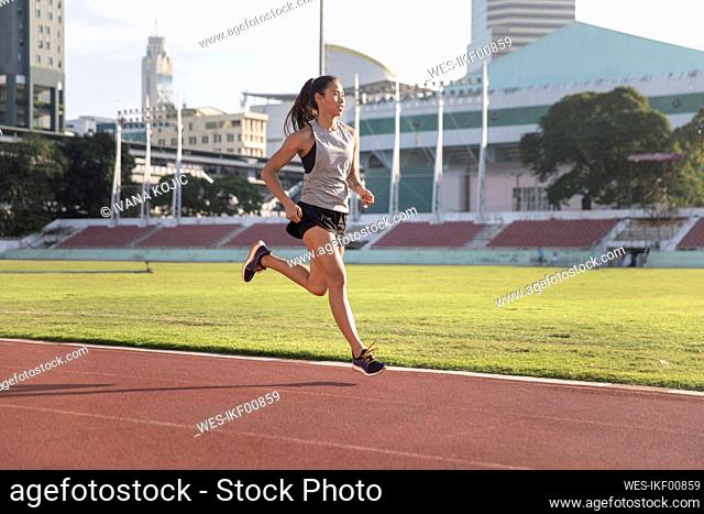 Young athlete sprinting in sports field