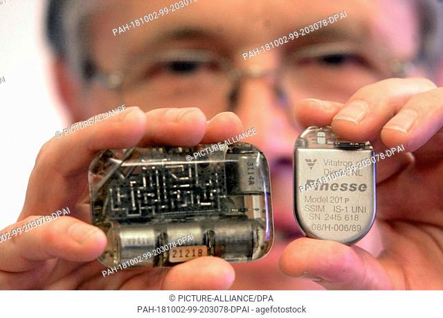 FILED - 27 February 2001, Saxony, Dresden: On the left a pacemaker from 1970, on the right a modern device that weighs only 20 grams and is much more powerful