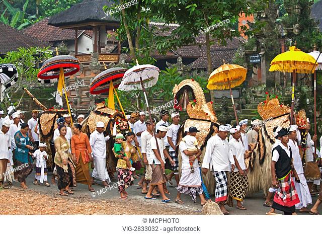 BARONG COSTUMES used in traditional LEGONG dancing are carried during a HINDU PROCESSION for a temple anniversary - UBUD, BALI - 03/12/2010