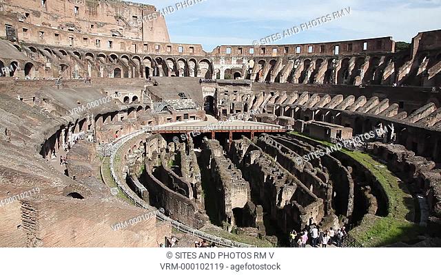 PAN, HA, Daylight. Interior: The Coliseum arena, showing the Hypogeum. The wooden walkway is a modern structure. The Coliseum is an elliptical amphitheater in...