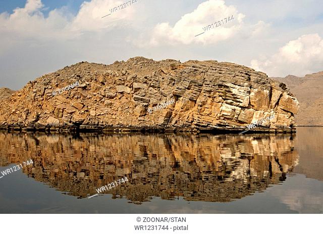 Water reflection of a cliff, Khor Ash Sham Fjord