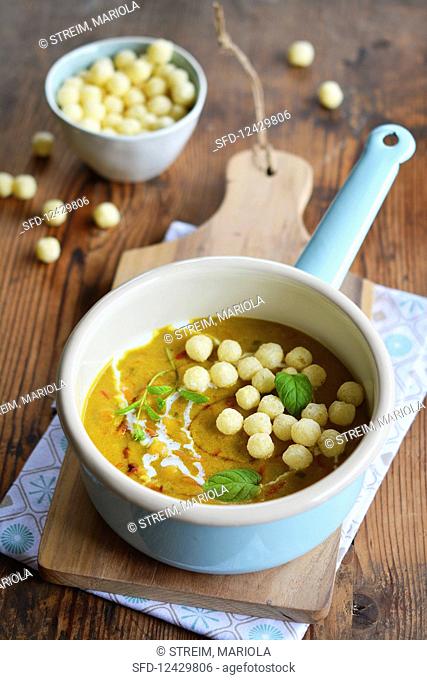Curry soup with millet balls in an enamel pan