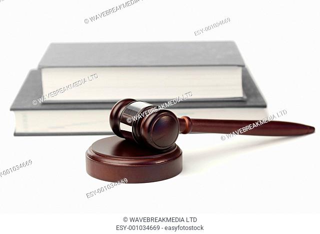 Gavel and grey books on a white background