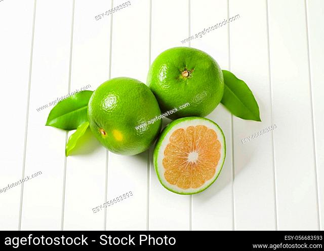 Two and a half sweetie fruits (green grapefruits, pomelits) and leaves