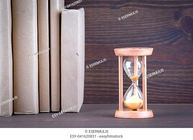 Sandglass, hourglass or egg timer on wooden table showing the last second or last minute or time out