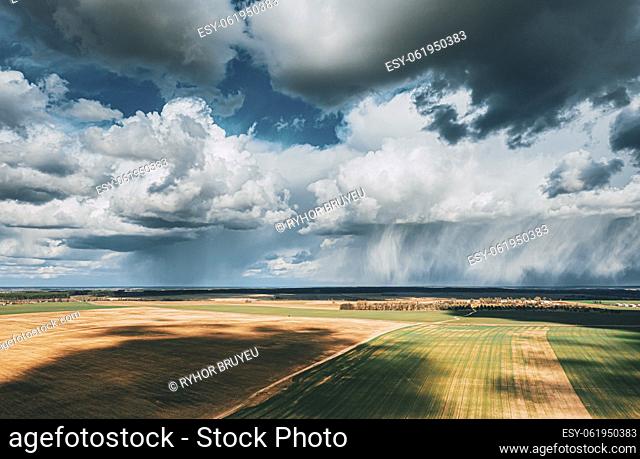 Scenic Sky With Fluffy Clouds On Horizon. Bird's-eye Aerial View. Amazing Natural Dramatic Sky With Rain Clouds Above Countryside Rural Field Landscape In...