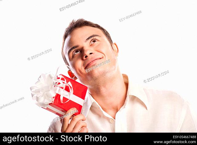 Close-up portrait of smiling man holding gift isolated on white background