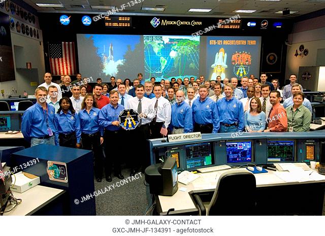The members of the STS-121 AscentEntry flight control team and crewmembers pose for a group portrait in the Shuttle (White) Flight Control Room of Houston's...