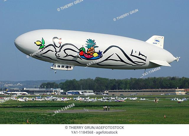 Airship dirigible Zeppelin NT taking off, Friedrichshafen airport, Baden-Württemberg, Germany.   Painting artist Stefan Szczesnys (nude woman) promoting the...