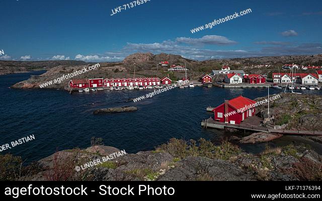 Red boat houses on the archipelago island of TjÃ¶rn in the west of Sweden