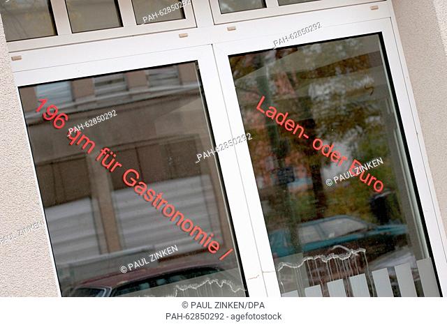 Lettering that reads '196 qm für Gastronomie / Laden- oder Büro' (lit. 196 square metres for gastronomy, stores or offices) seen on a window pane of a building...