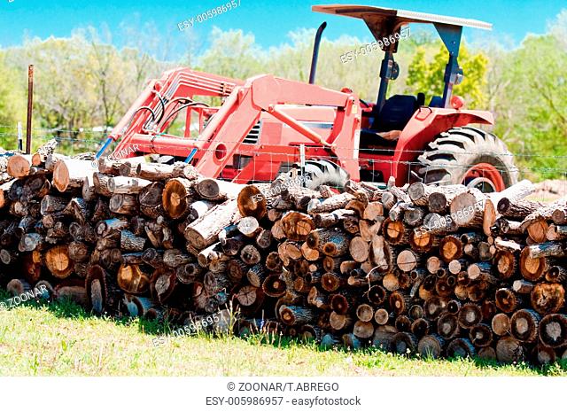 Stack of firewood and tractor