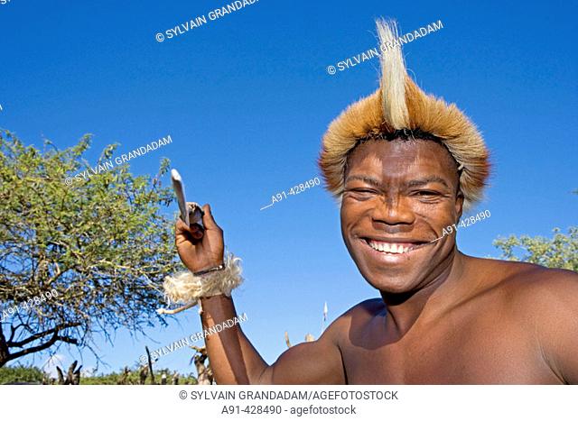 Zulu fighting with a spear. The Simunye zulu village where visitors can be accomodated in zulu style, traditional chief Biyela. Kwazulu-Natal province