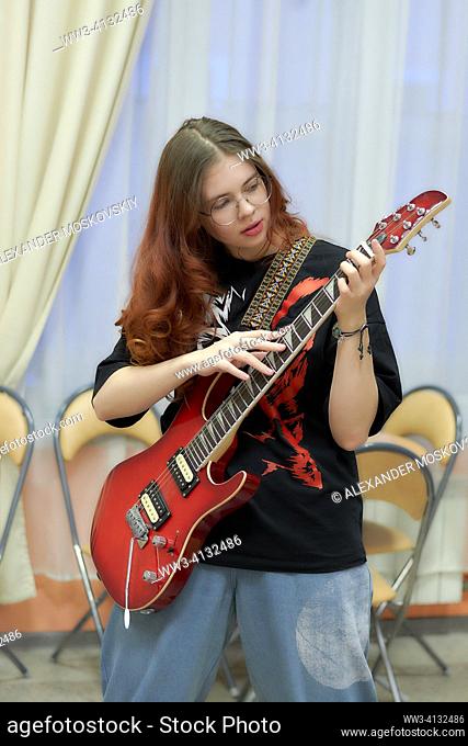 Pretty Young Girl plaing on Guitar