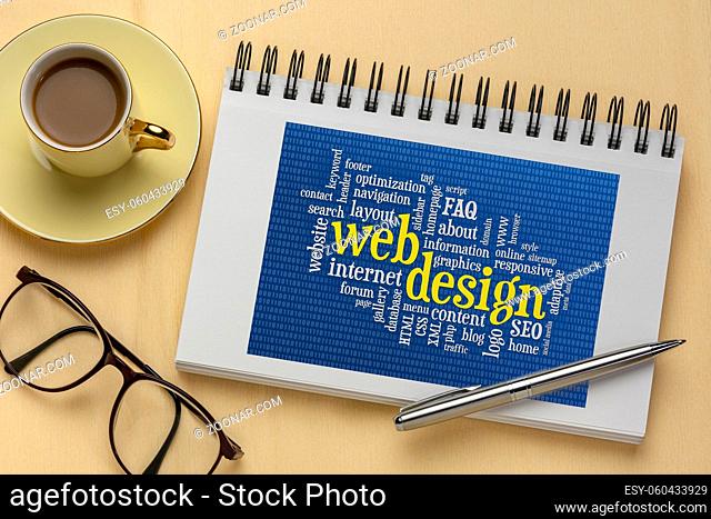 web design and development word cloud with binary background in a spiral sketchbook, flat lay with a cup of coffee