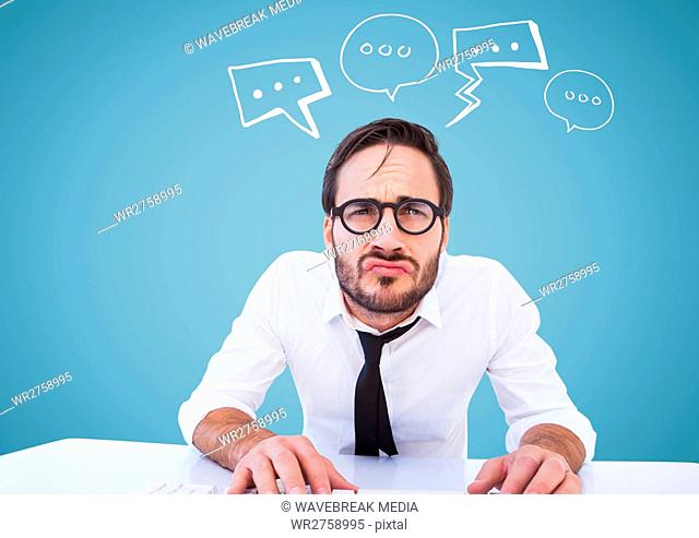 Man at desk with white speech bubbles against blue background