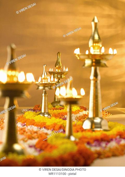Brass lamps and flowers decoration during diwali festival ; India