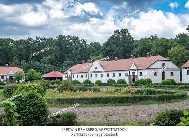 A dirt horse track and small grass field lie in front of the horse stables at Stado Orgierow ŠÄ…ck - stud farm / stallion breeder, ŠÄ…ck, Masovian Voivodeship