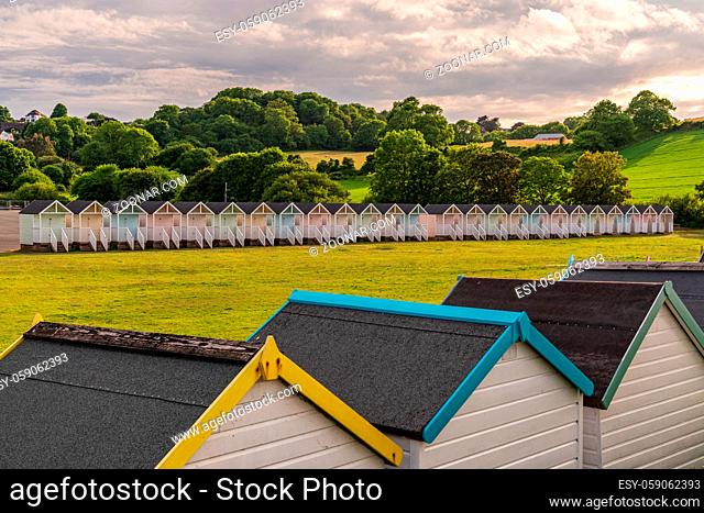 Beach Huts on the grass near the Promenade in Broadsands, Torbay, England, UK